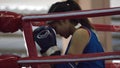 The woman boxer in the ring of thai boxing indoor have to practice first isÃ¢â¬ÅWaiKruÃ¢â¬Â.